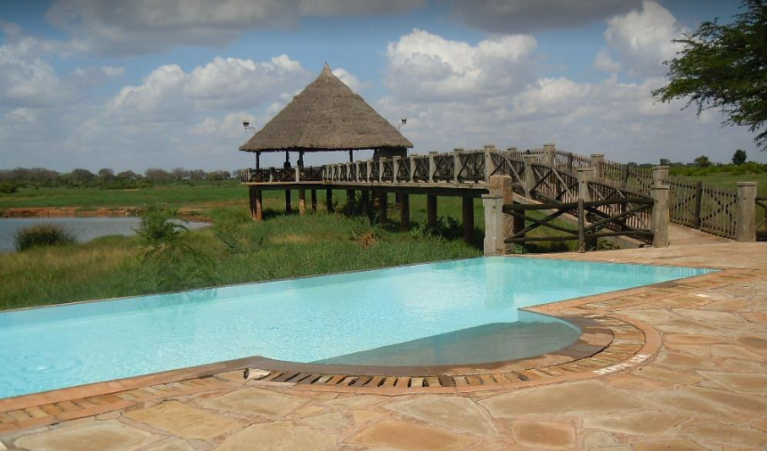 Voi Wildlife Lodge Swimming Pool with waterhole view